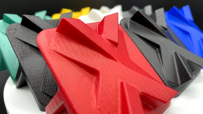 Array of 3D printed vapor smoothed parts dyed various colors
